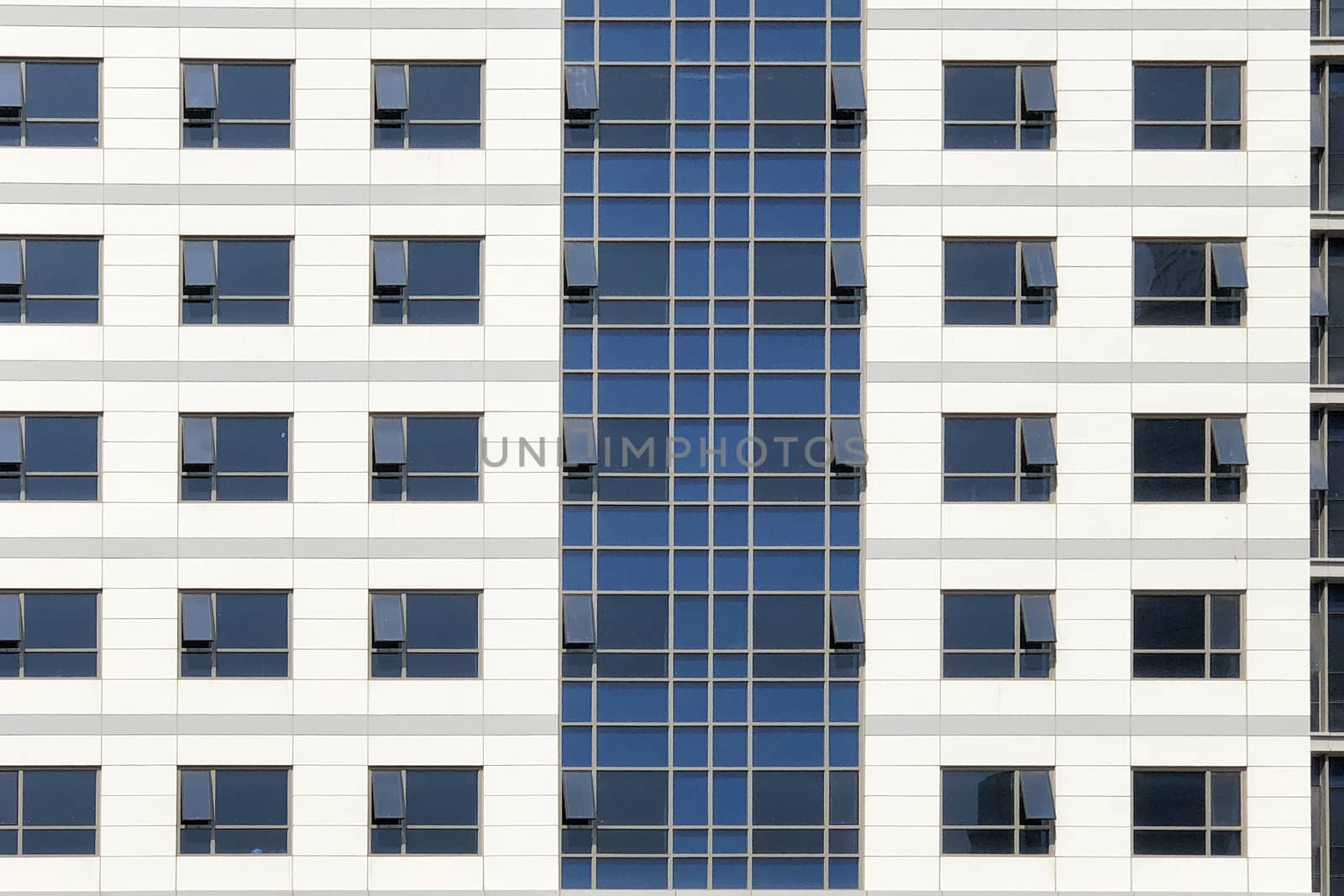 Glass windows of white office building background