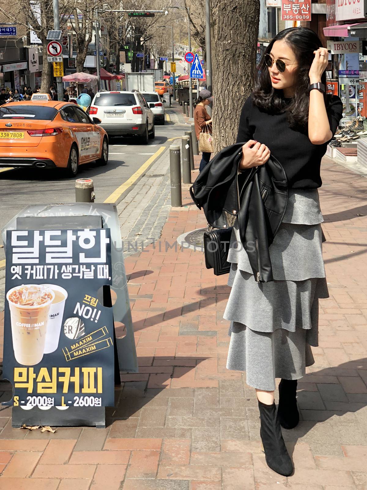 Seoul, South Korea 30 March 2018 : Young beautiful woman shopping and walking around Ewha Womens University Fashion Street which is one of the most popular shopping area