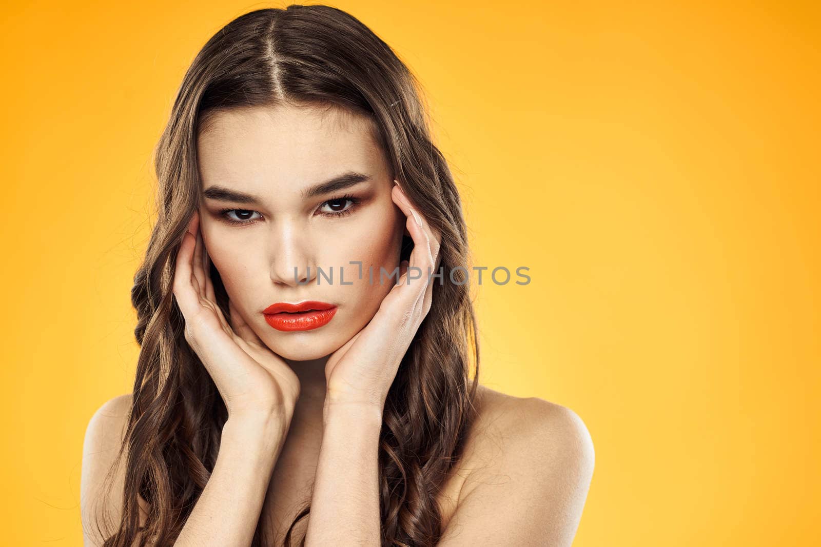 Woman with bare shoulders red cropped lips charm yellow background. High quality photo