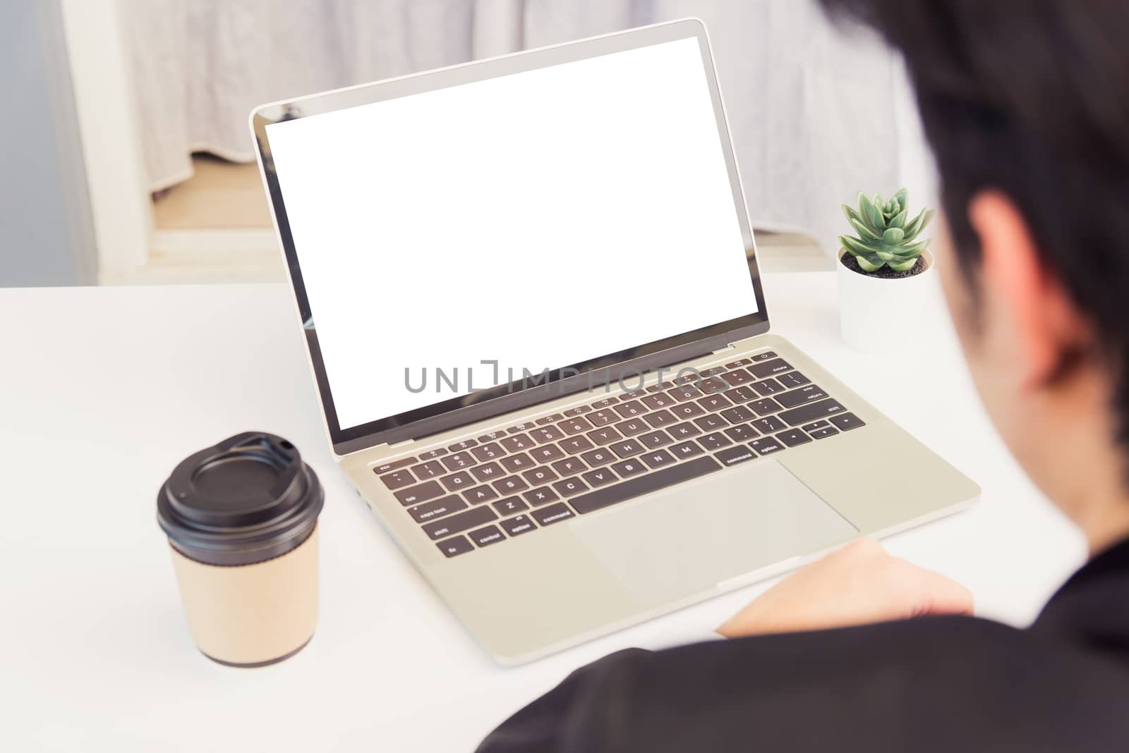 Work from home, Asian young businessman smile wearing suit video conference call or facetime by laptop computer sitting and listening to teammates explained on desk at home office