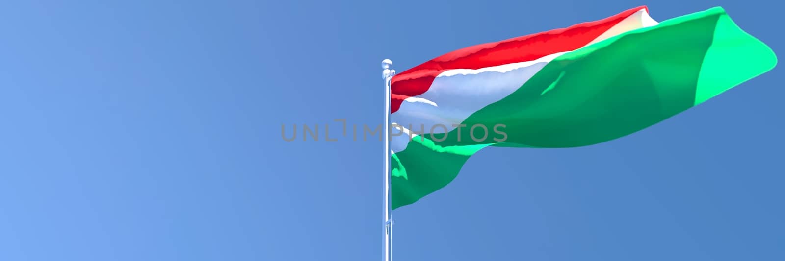 3D rendering of the national flag of Hungary waving in the wind against a blue sky.