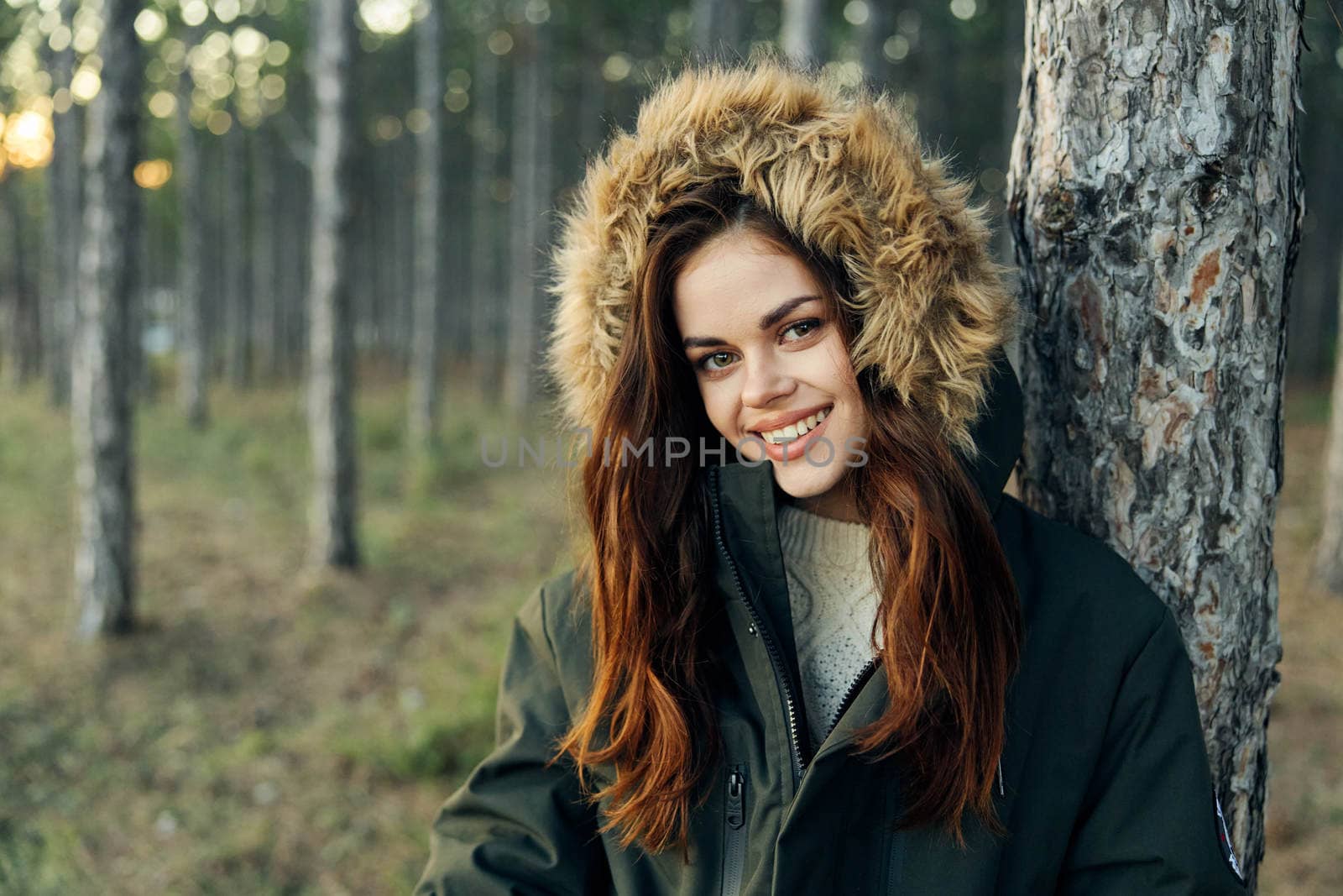 Smiling woman on nature tourism as a lifestyle near a tree. High quality photo