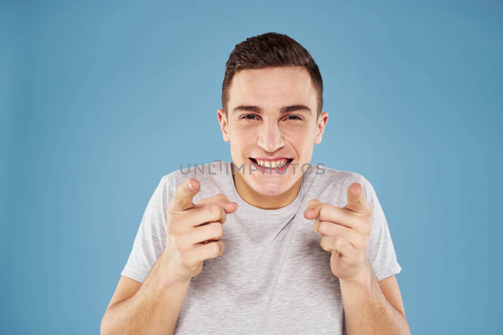 Emotional man in white t-shirt cropped view on blue background lifestyle by SHOTPRIME