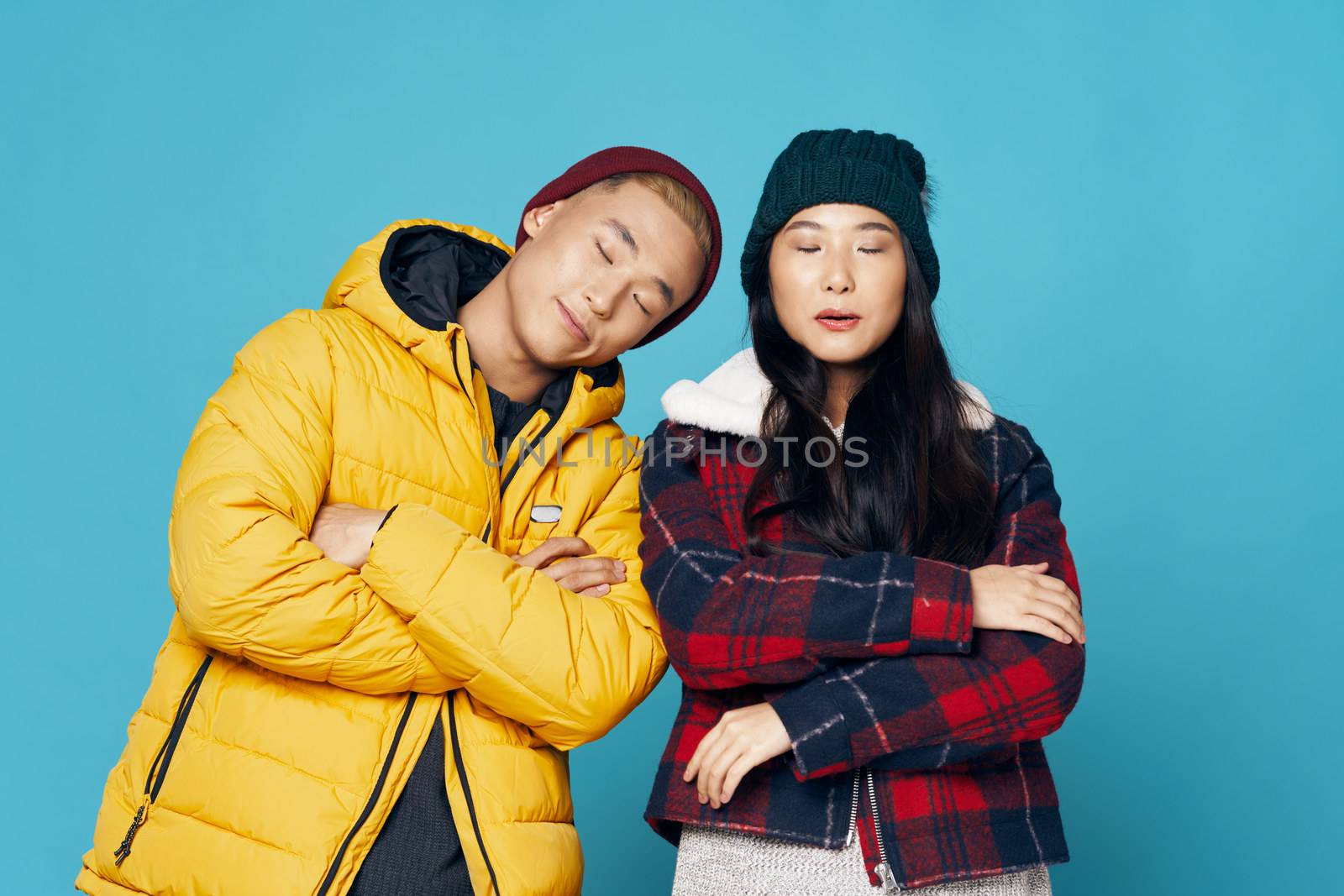 Man and woman in fashionable clothes of Asian appearance blue communication by SHOTPRIME