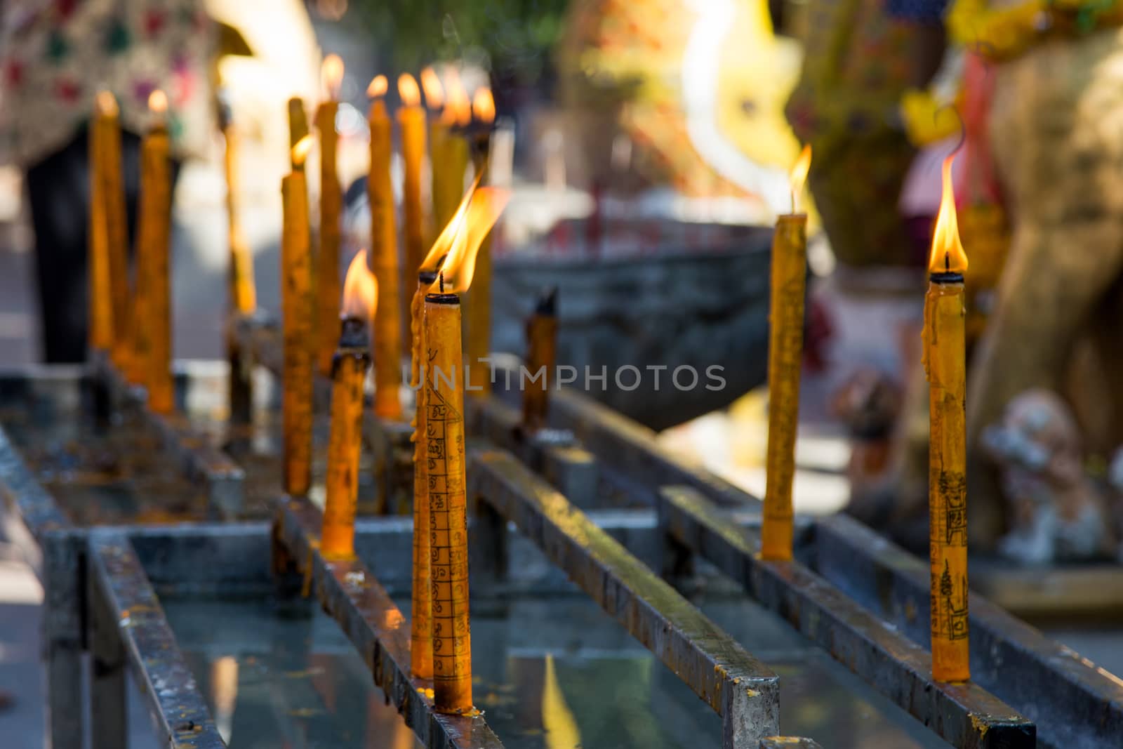 Thailand dog temple, Wat Ket Karem, with votive lighted candles with statues and sleeping dogs and votive offerings. High quality photo