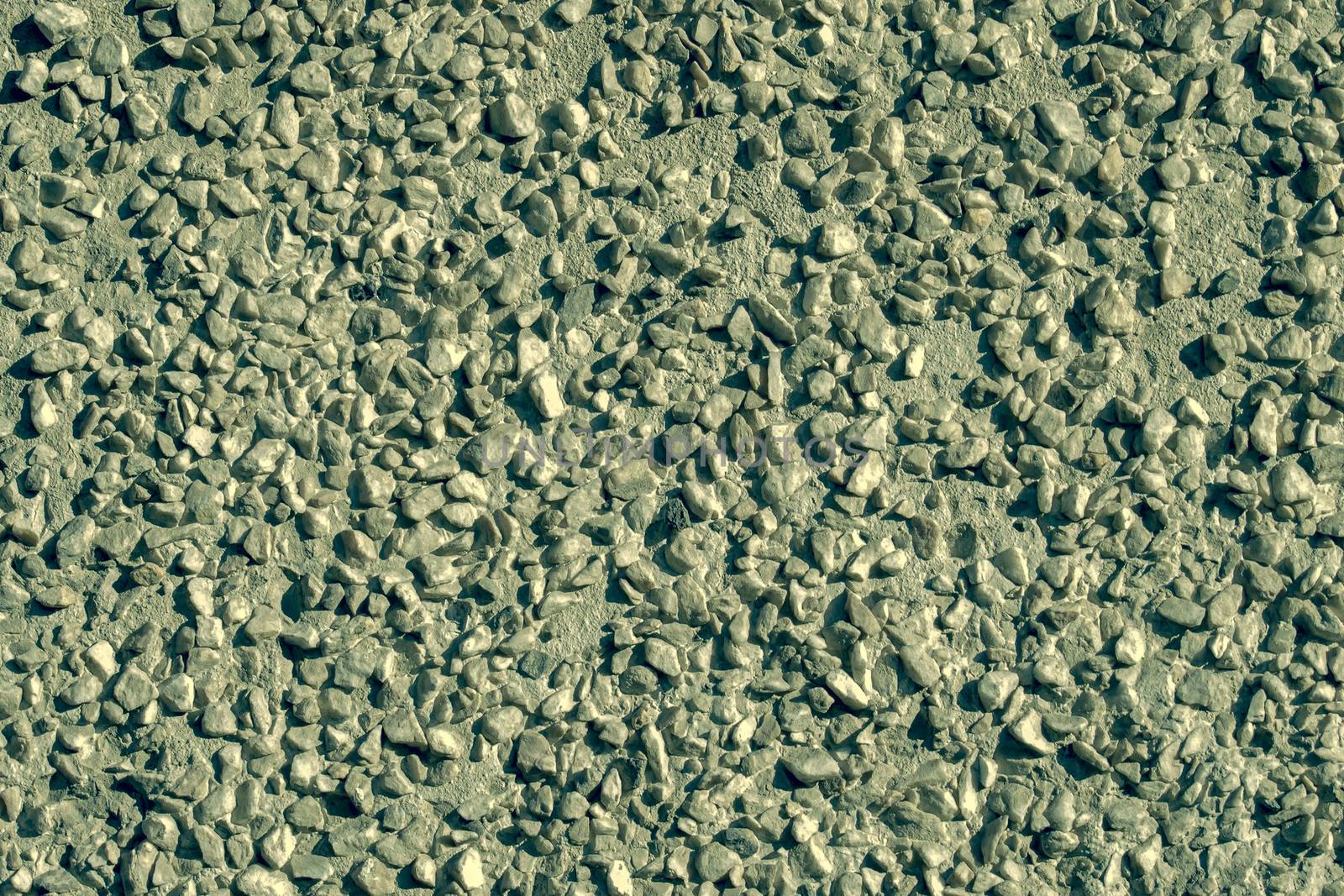 View from the front. Small pebbles in concrete. Abstraction.