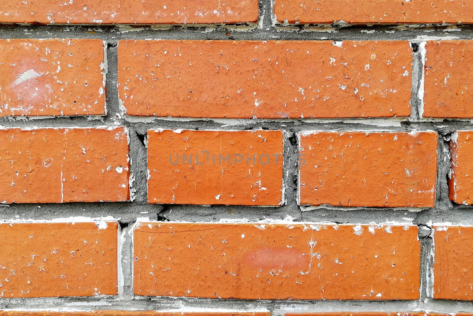 There is white salt on the cement joints. Front view. Abstract textured background.