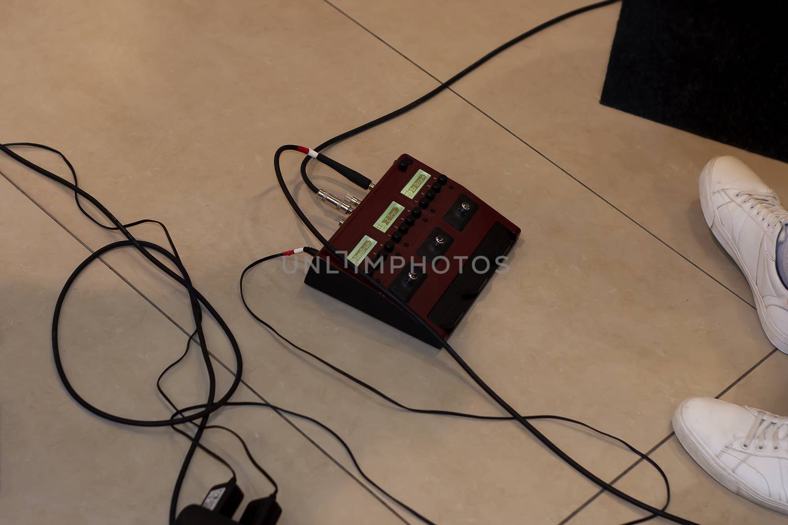 On the floor. There's a guitarist nearby. We've had his legs in sneakers and wires.