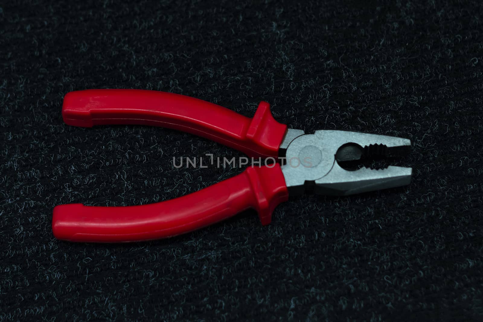 Pliers tool on black background for works