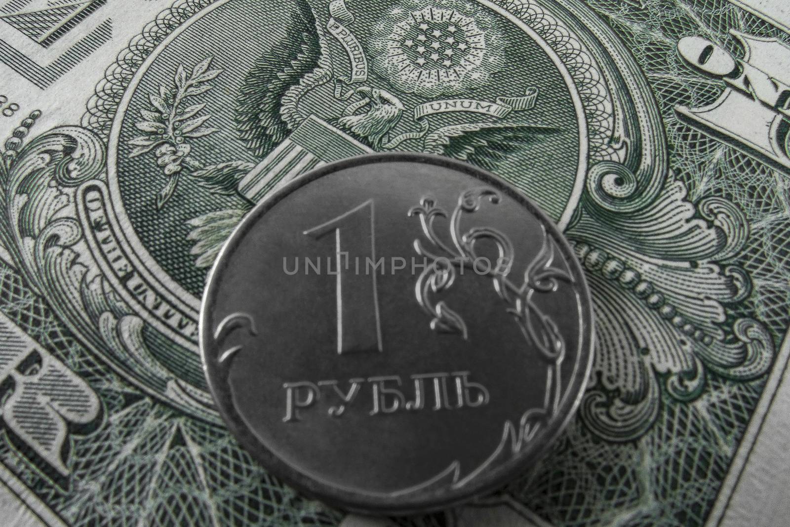 One ruble coin on a paper dollar. National currency devaluation