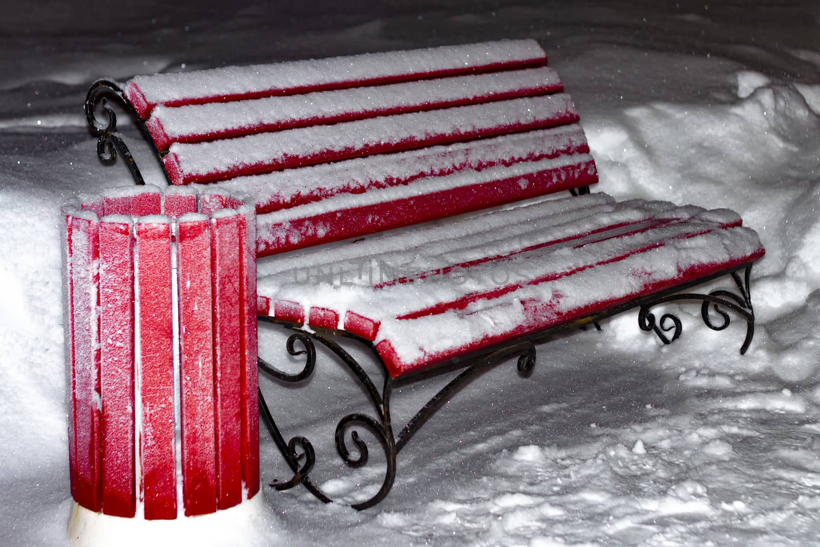Red bench in winter. City of Siberia.