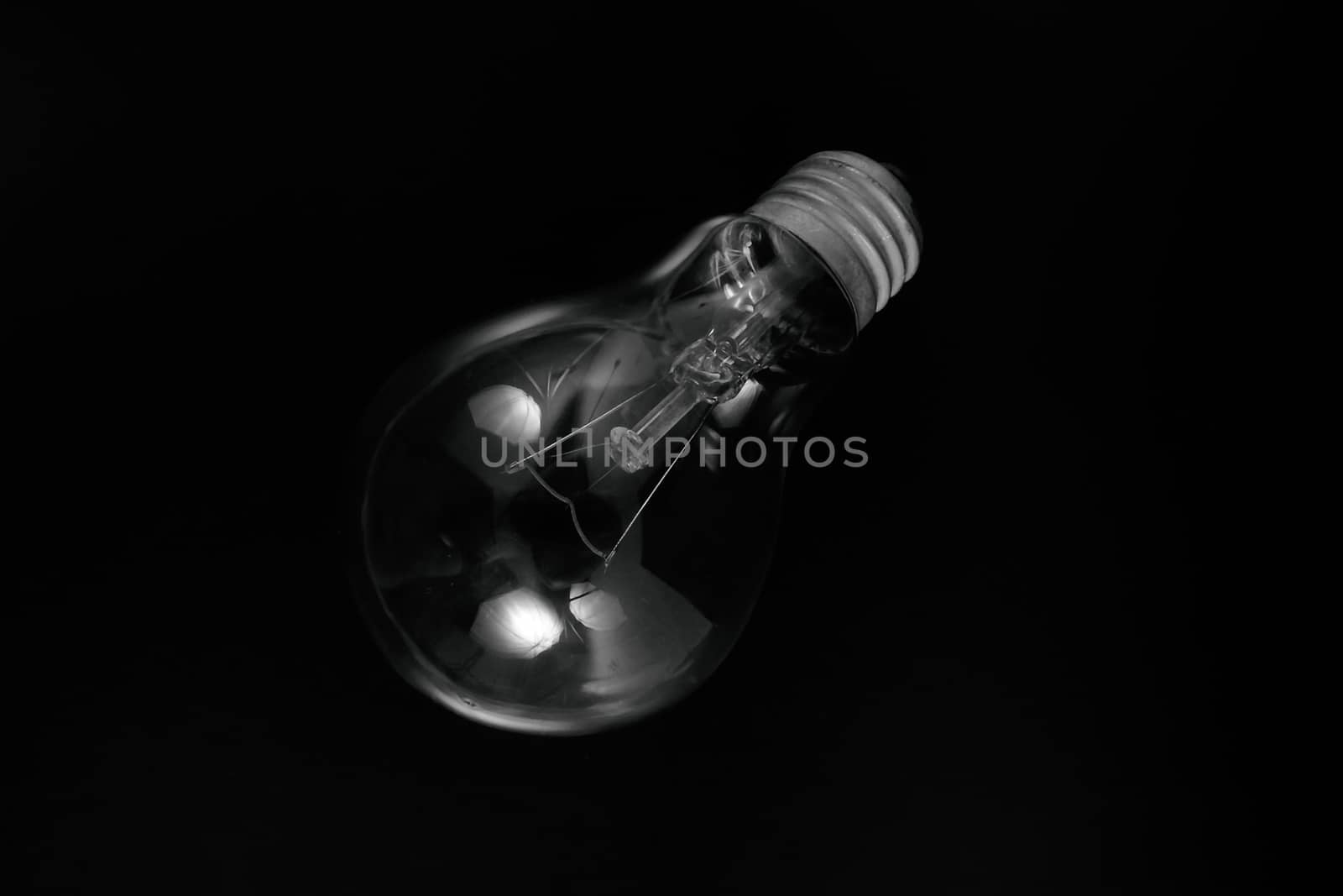 Incandescent light bulb on a black background