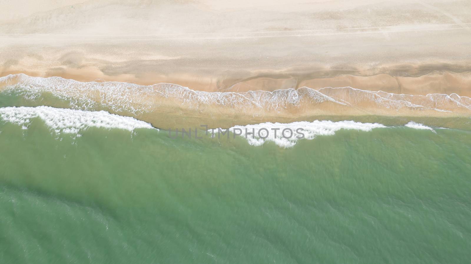 Aerial view of a Mediterranean sandy beach and its waves by Frederic