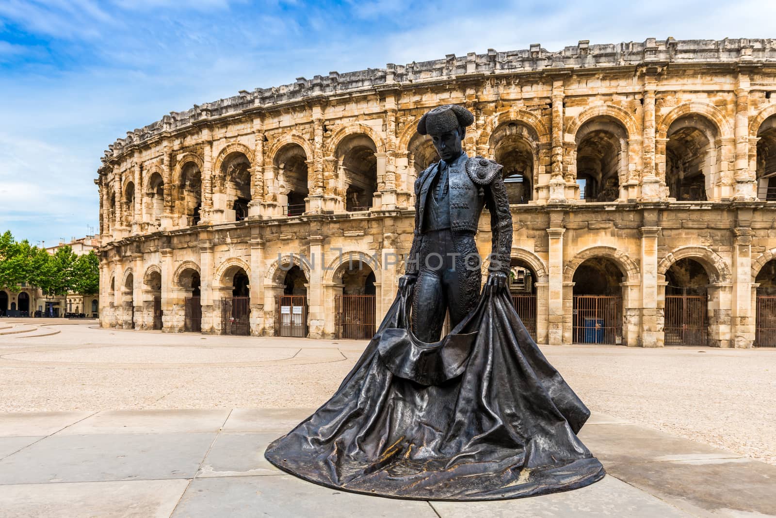 Statue of a bullfighter in front of the arenas of Nîmes in Gard in Occitanie, France by Frederic