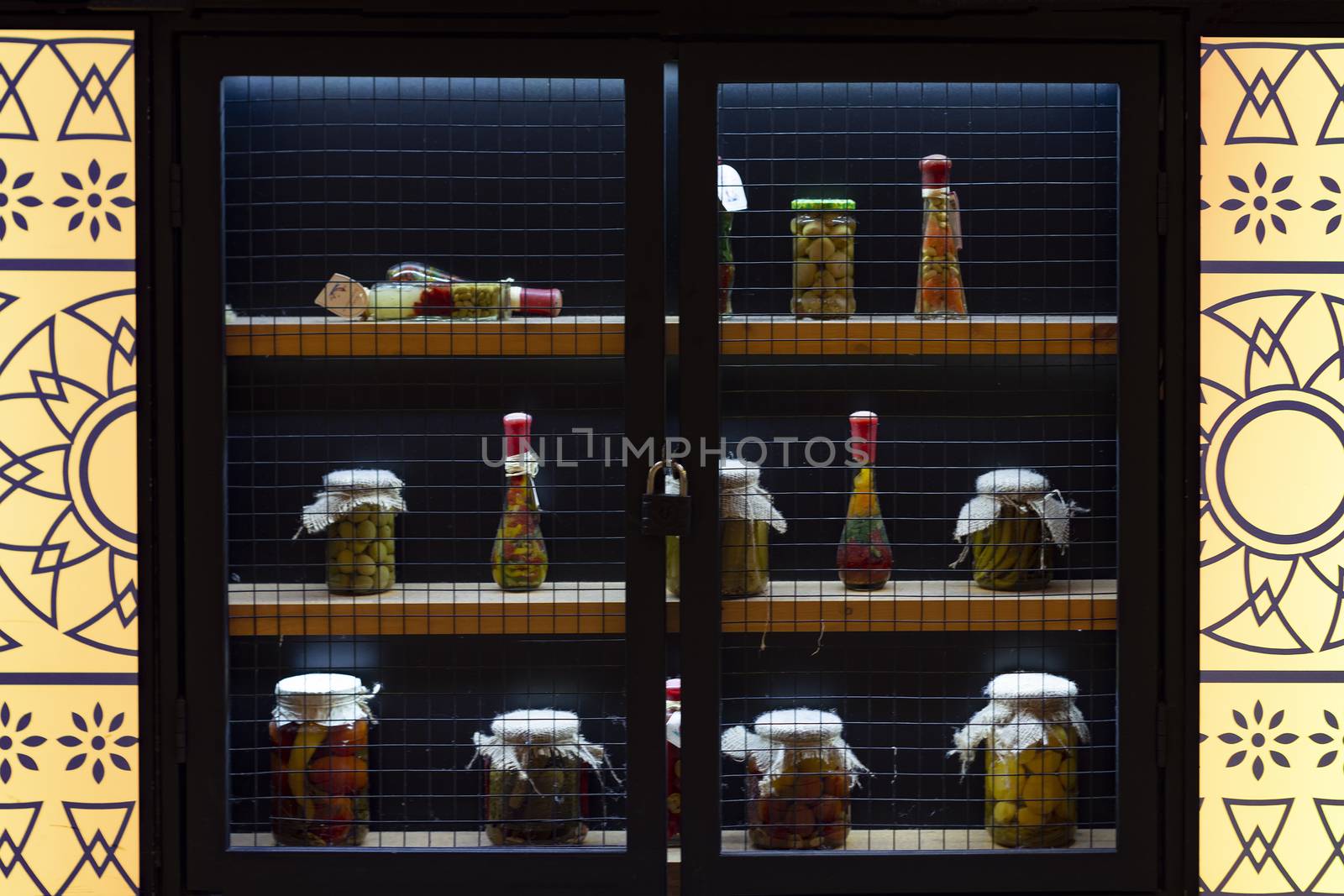 Bottles and cans in the window with lights.