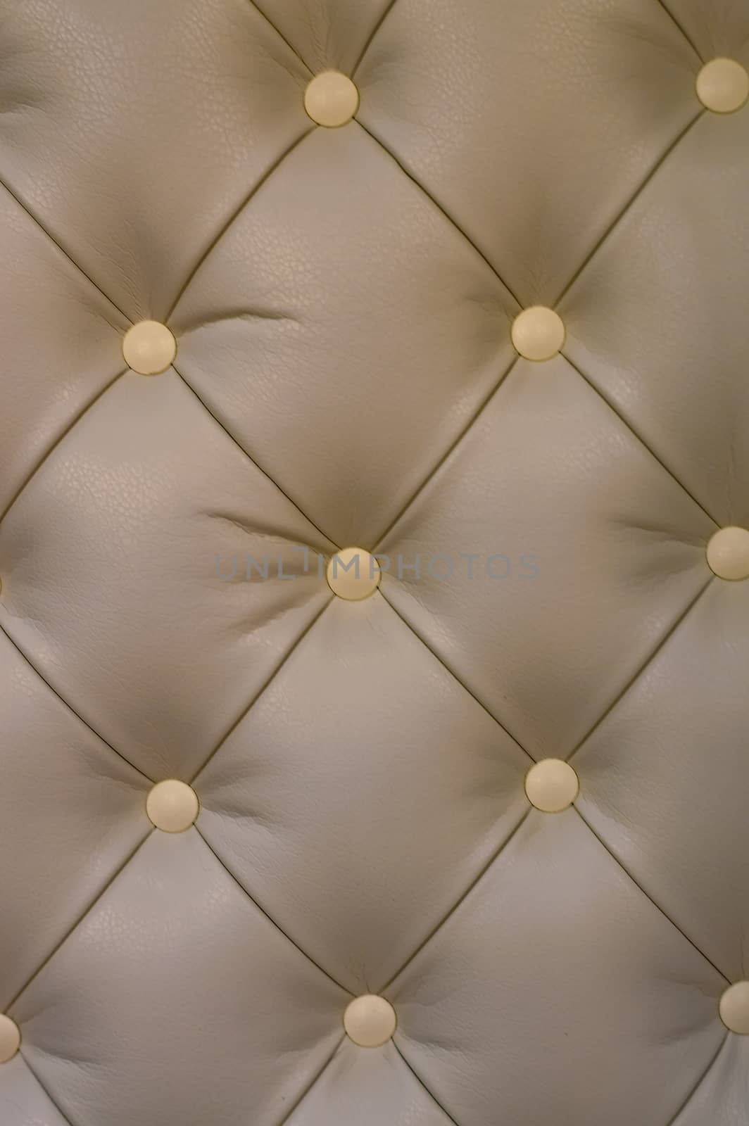Textural rhomb ornament on dark upholstery. Front view. Close up.