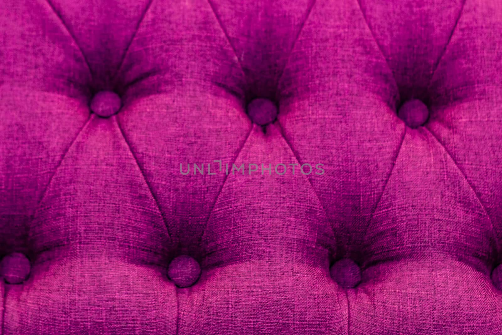 Textural pink rhomb ornament on brown upholstery. Close up. by Essffes