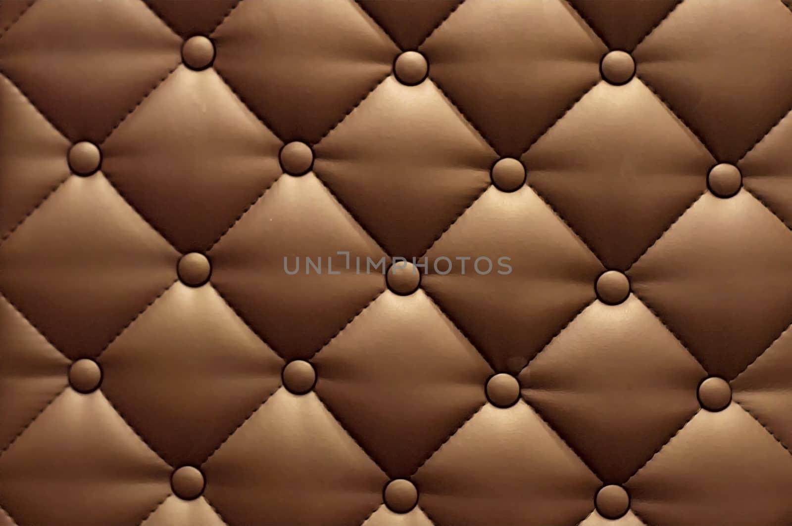 Textural rhomb ornament on brown upholstery. Close up. by Essffes