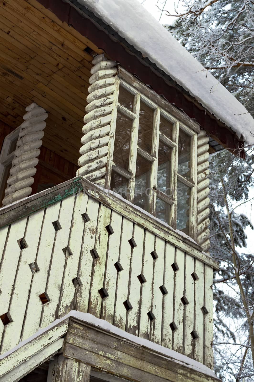 A porch with an entrance to the second floor of a wooden house. View from above.