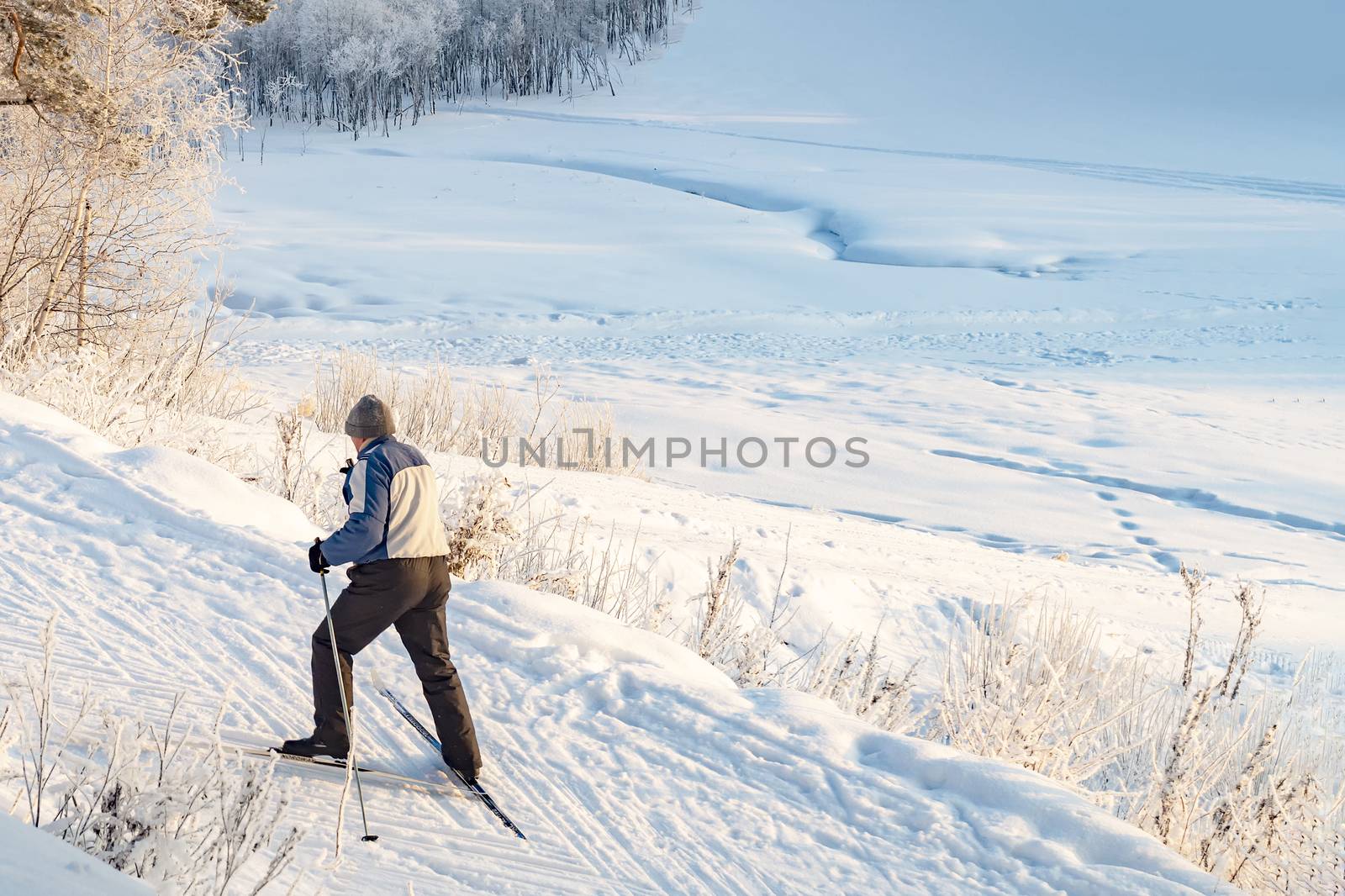 Skier man moves uphill. View from above. New