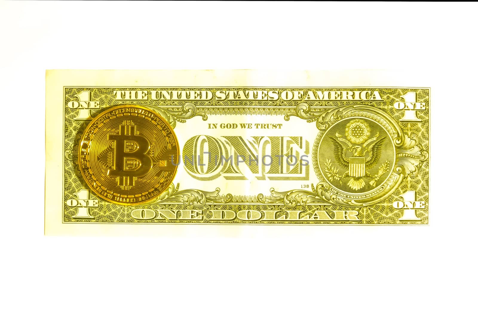 One dollar bill and a bitcoin coin. Isolate the view from above.