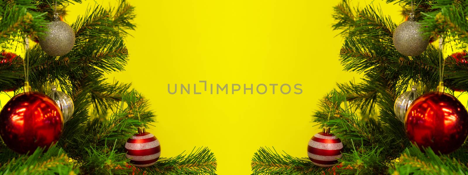 New Year and Christmas background with copy spase. Christmas branches frame on yellow.