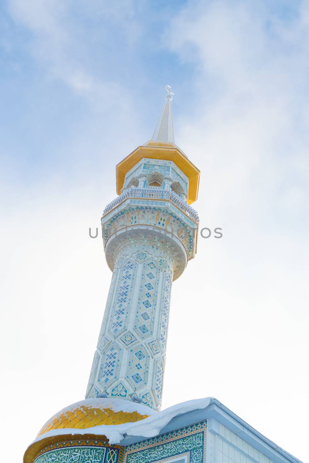 Minaret of mosque in Siberian city. Horizon is littered with author's idea.