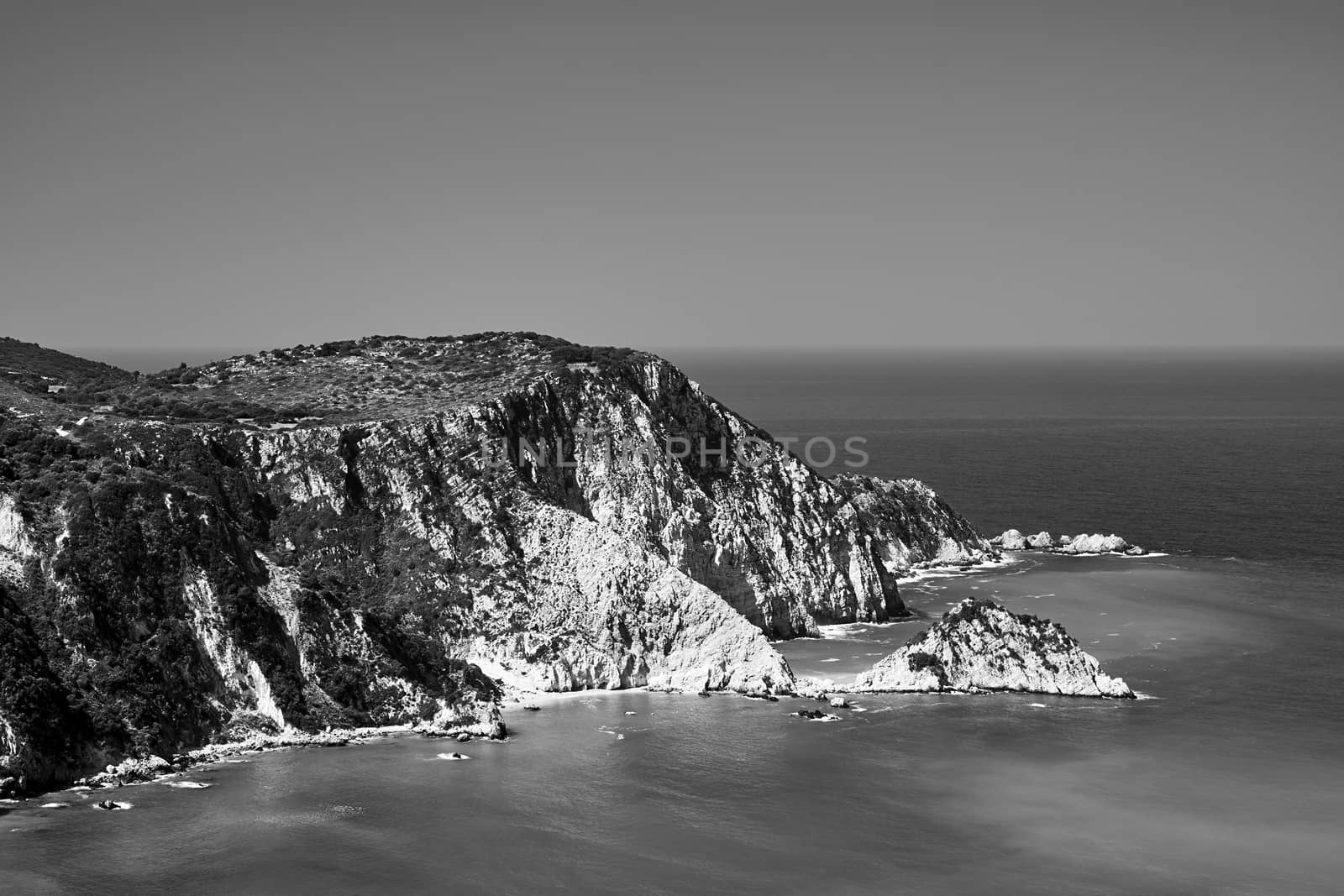 Rocky coast at Petani Bay on the island of Kefalonia in Greece, monochrome