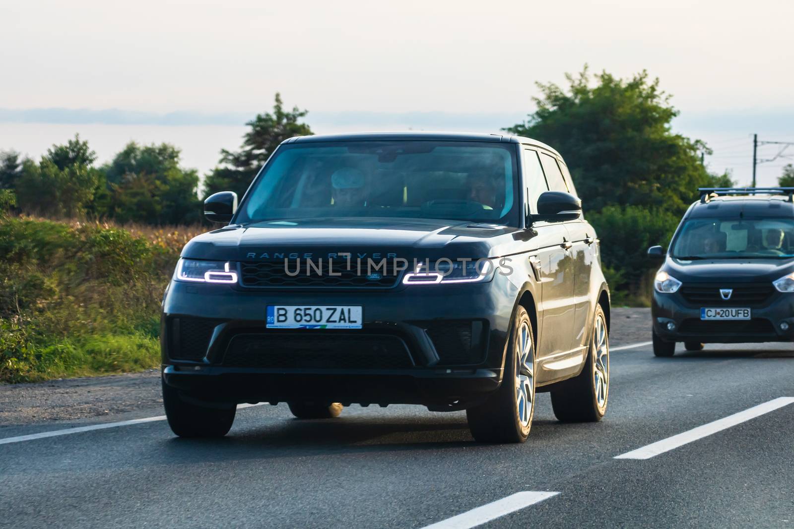 Traveling Range Rover car in motion on asphalt road, front view of car on street. Bucharest, Romania, 2020