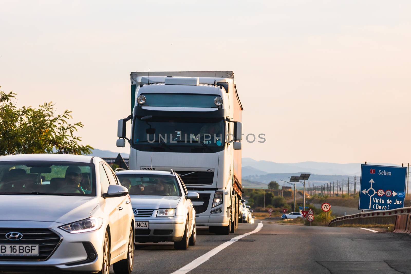 Traveling cars in motion on asphalt road, front view of cars in  by vladispas