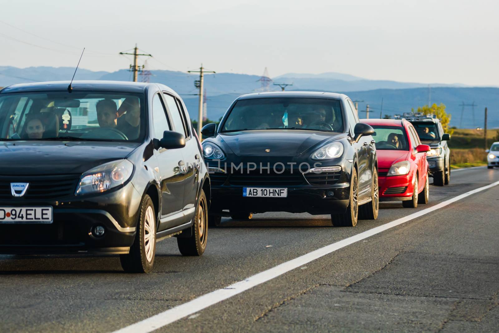 Traveling cars in motion on asphalt road, front view of cars in row on street. Bucharest, Romania, 2020