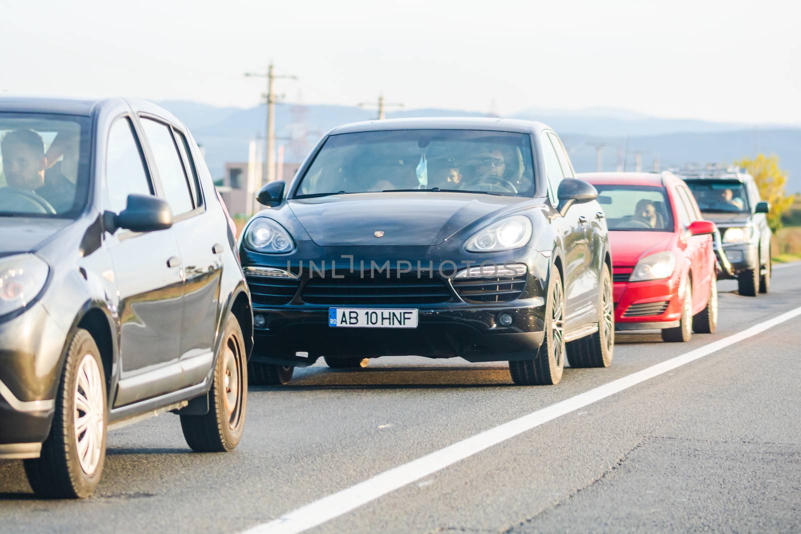 Traveling cars in motion on asphalt road, front view of cars in  by vladispas