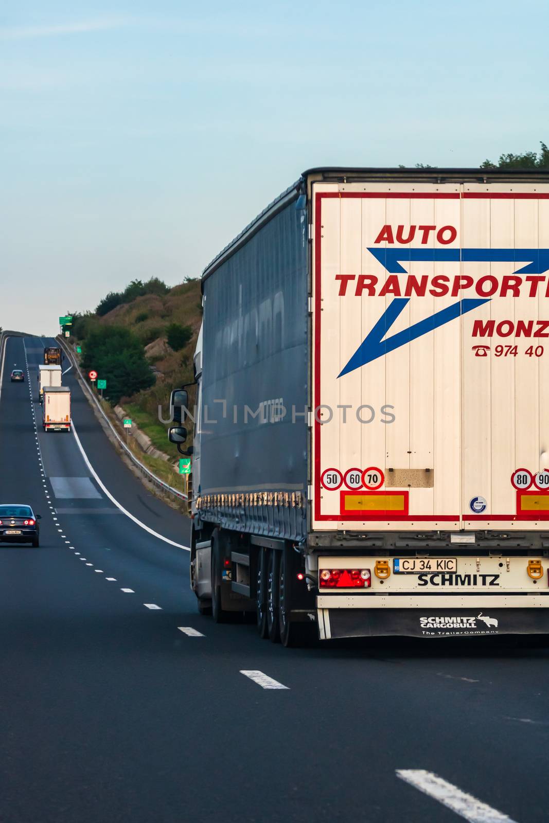 Side view of loaded European truck in motion on asphalt road, transportation and delivery concept. Detail on delivery truck. Bucharest, Romania, 2020