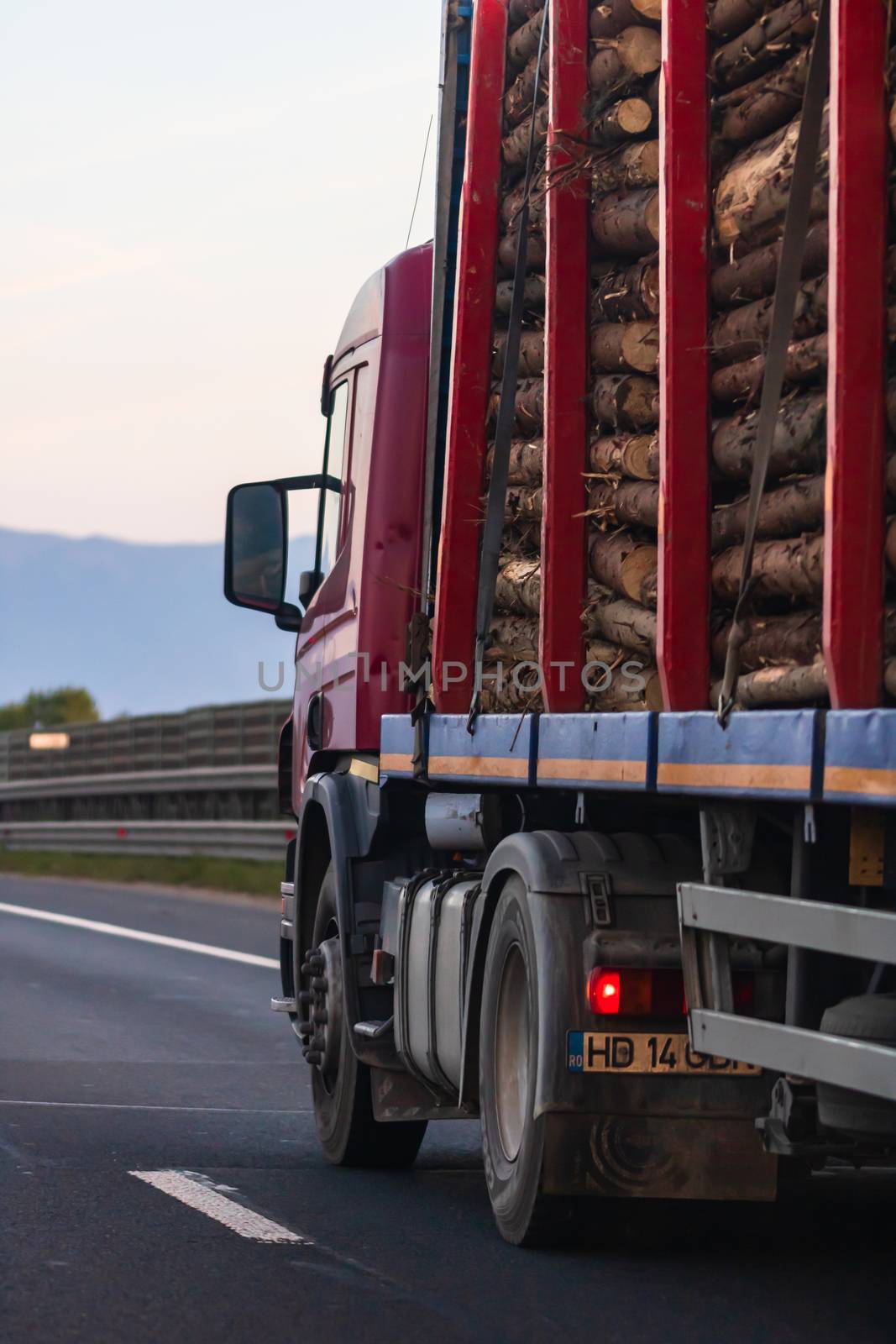 Side view of loaded European truck in motion on asphalt road, transportation and delivery concept. Detail on delivery truck. Bucharest, Romania, 2020