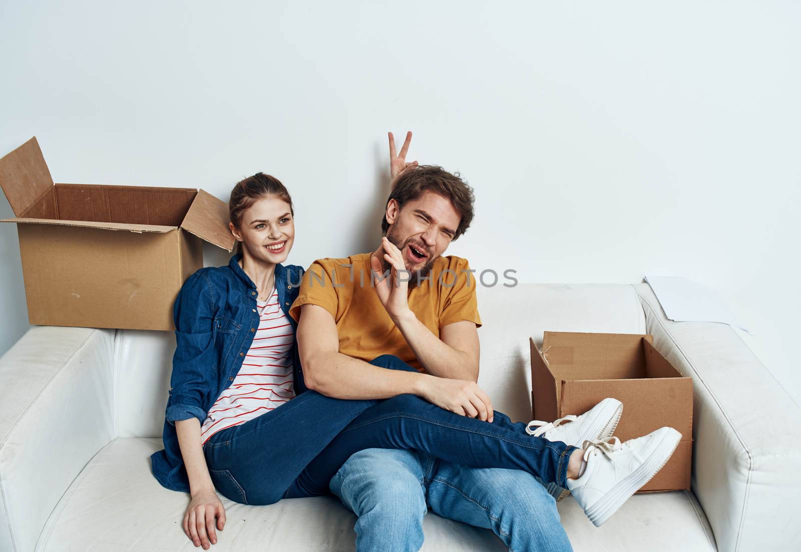 Man and woman in a new apartment boxes with things interior. High quality photo
