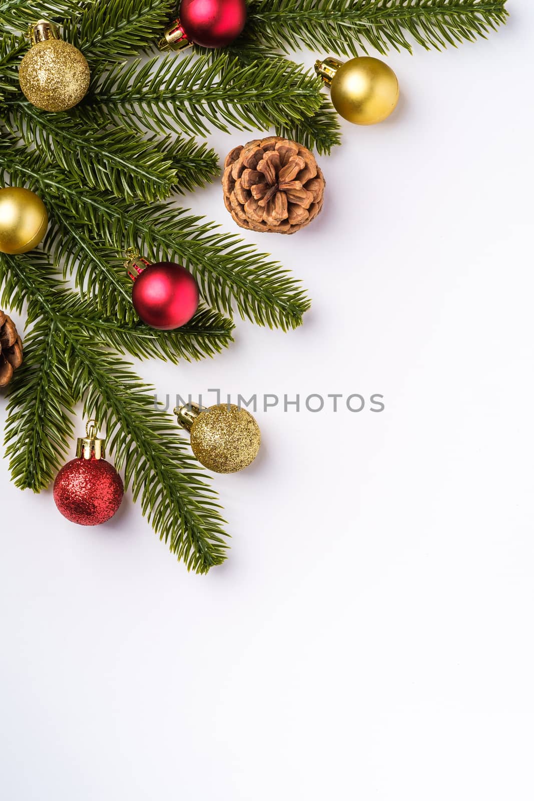 Christmas composition with copy space. Colorful ornament, baubles and fir needles decorations, top view