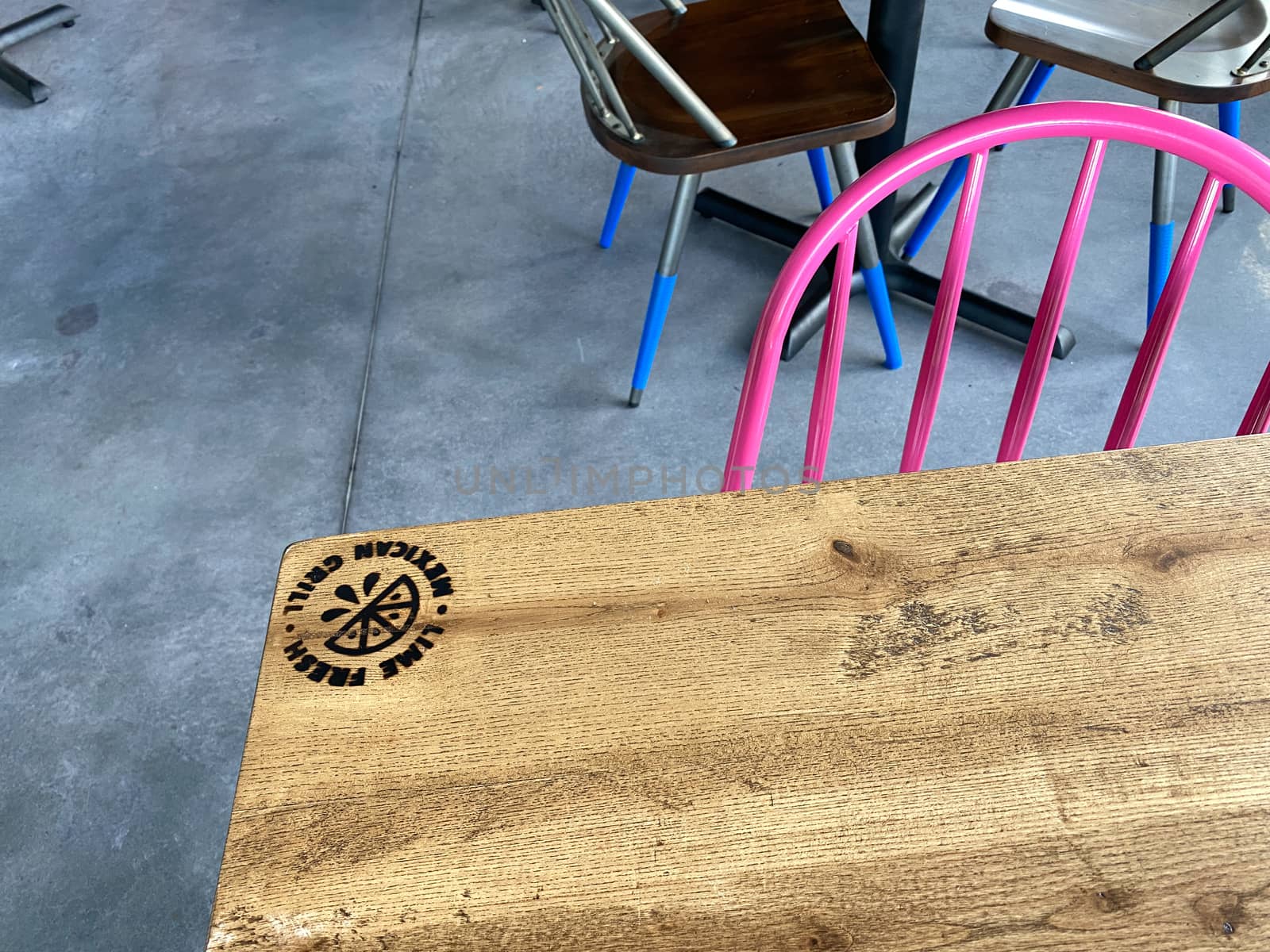 Orlando,FL/USA-10/25/20: The interior wooden table with burned in logo of a Lime Fresh Mexican Grill in  Orlando, FL.