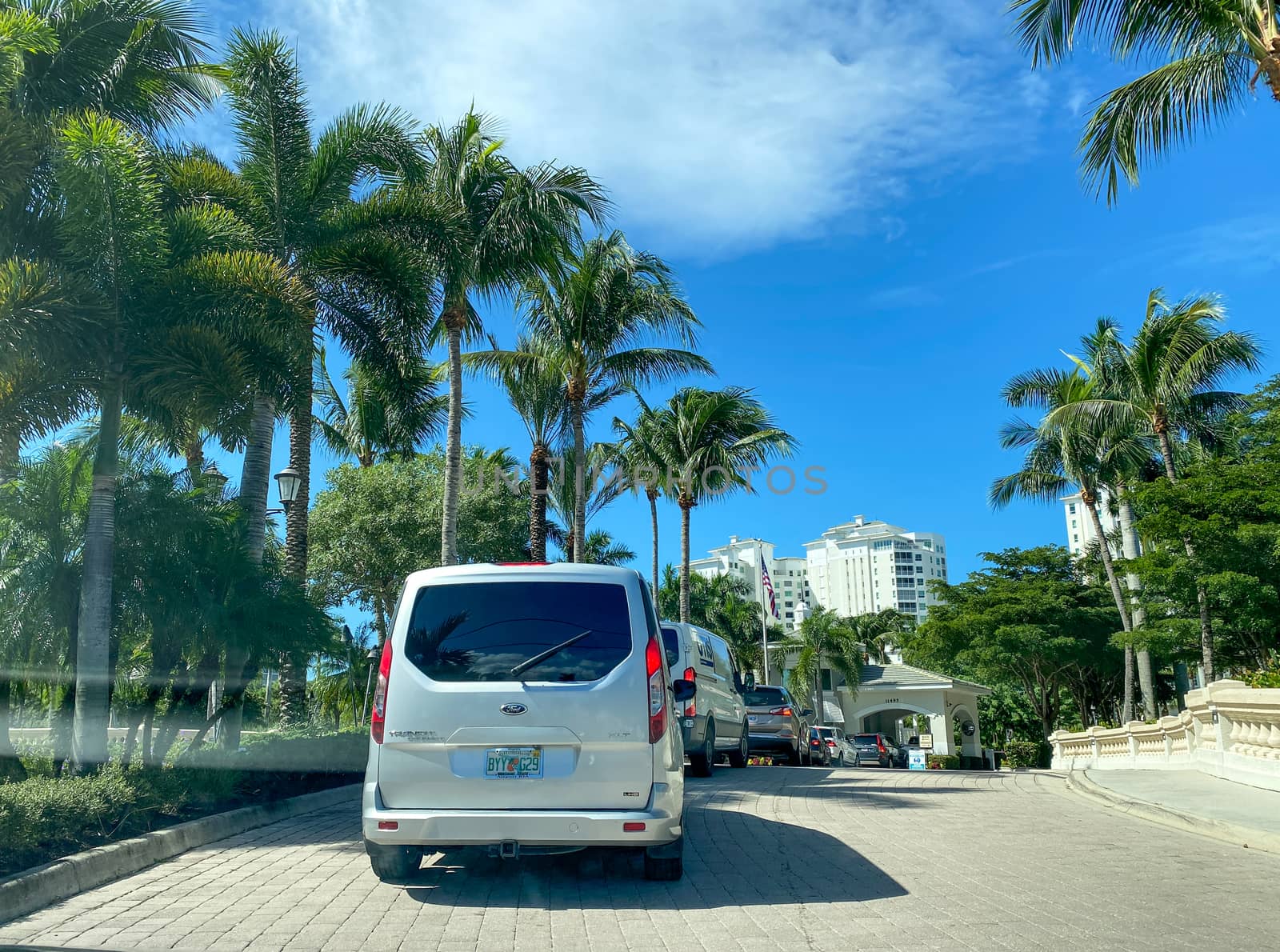 Naples, FL/USA - 10/29/20:  A line of cars waiting to check into the security guard at a luxury condominium in Naples, Florida.