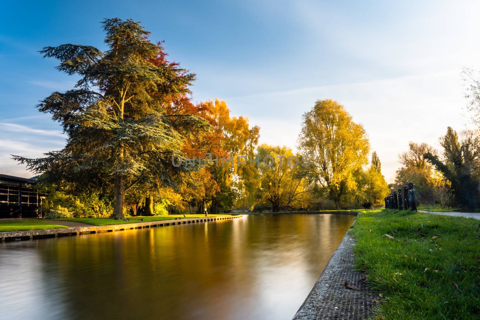 Lon exposure image of the river Cam in warm afternoon light in autumn, Cambridge