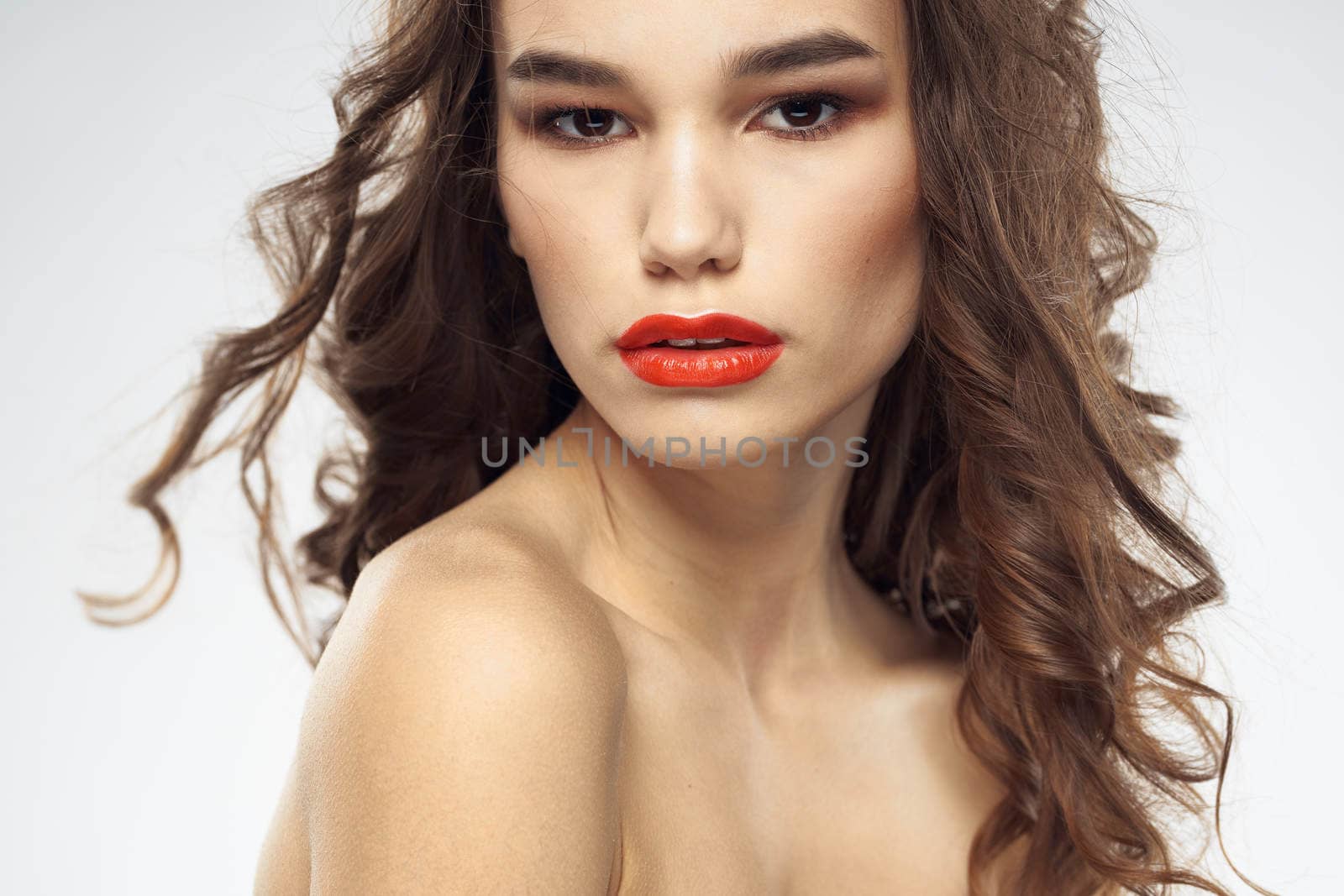 Beautiful woman with drawn swords bright makeup glamor close-up light background. High quality photo