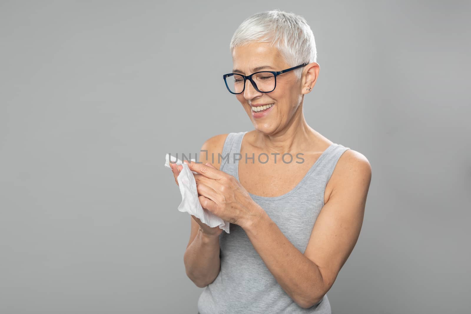 Senior woman cleaning hands with wet wipes, prevention of infectious diseases, covid19
