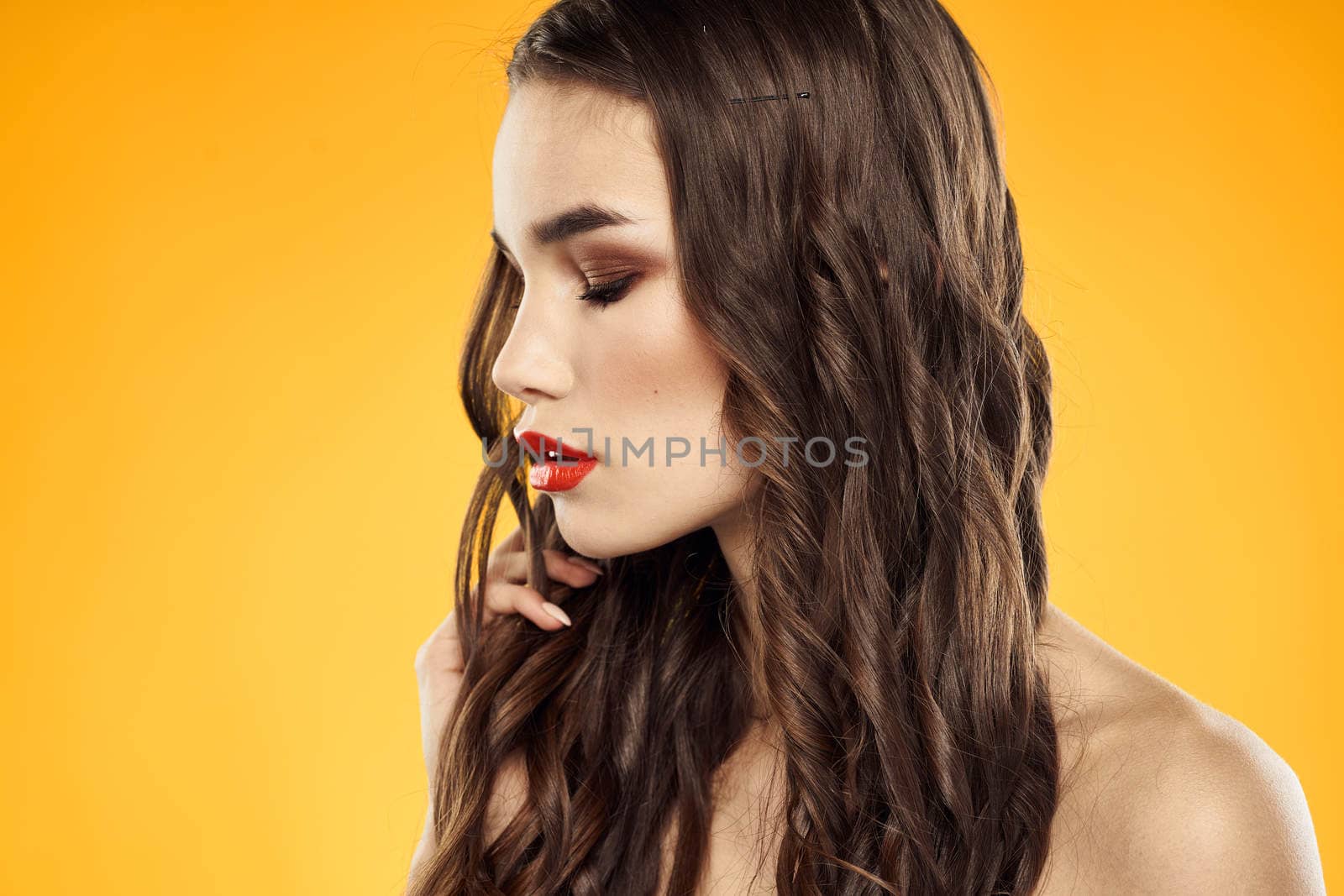 Woman with bare shoulders red cropped lips charm yellow background. High quality photo