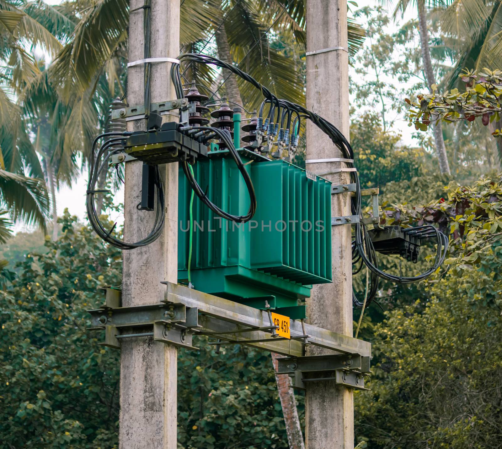 Elevated green transformer in the street of Sri Lanka