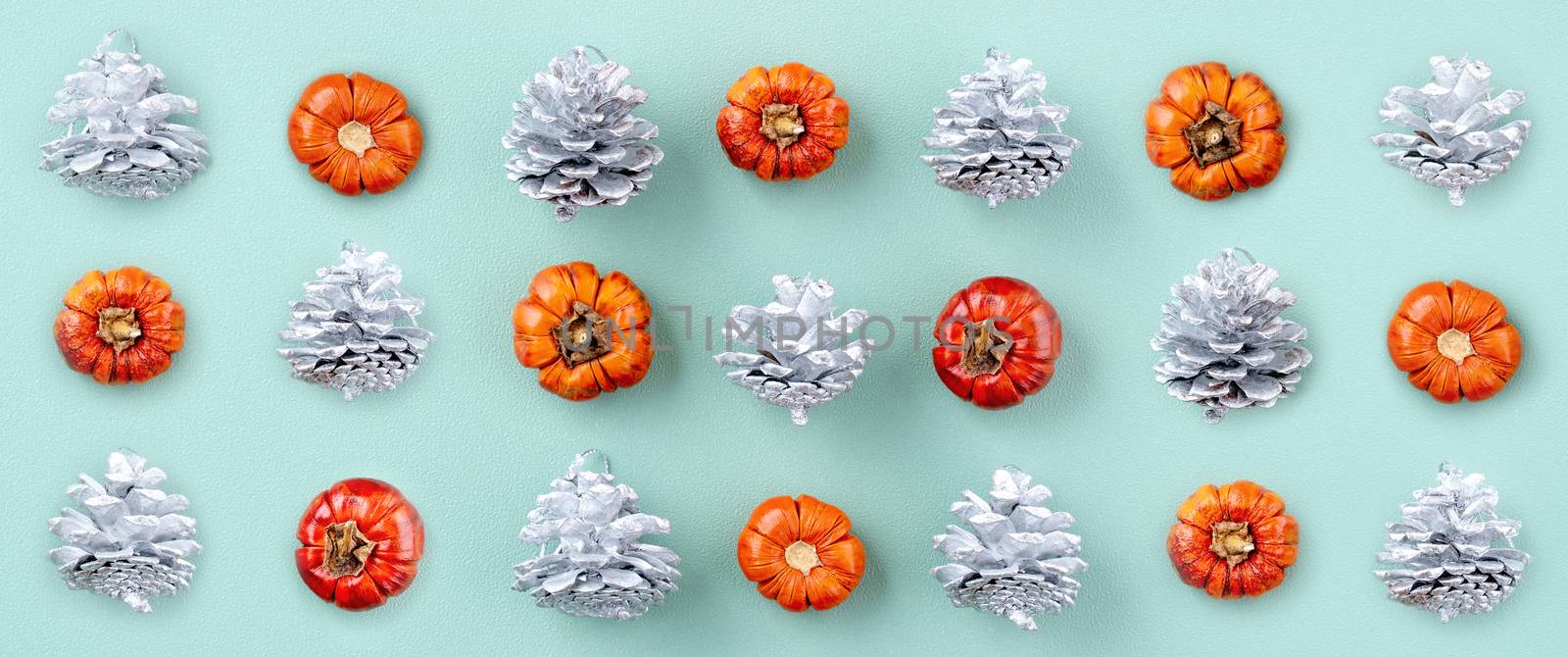 Top view of Christmas holiday decoration ornament composition with Christmas tree, gift star, gingerbread man flat lay with copy space isolated on green background.