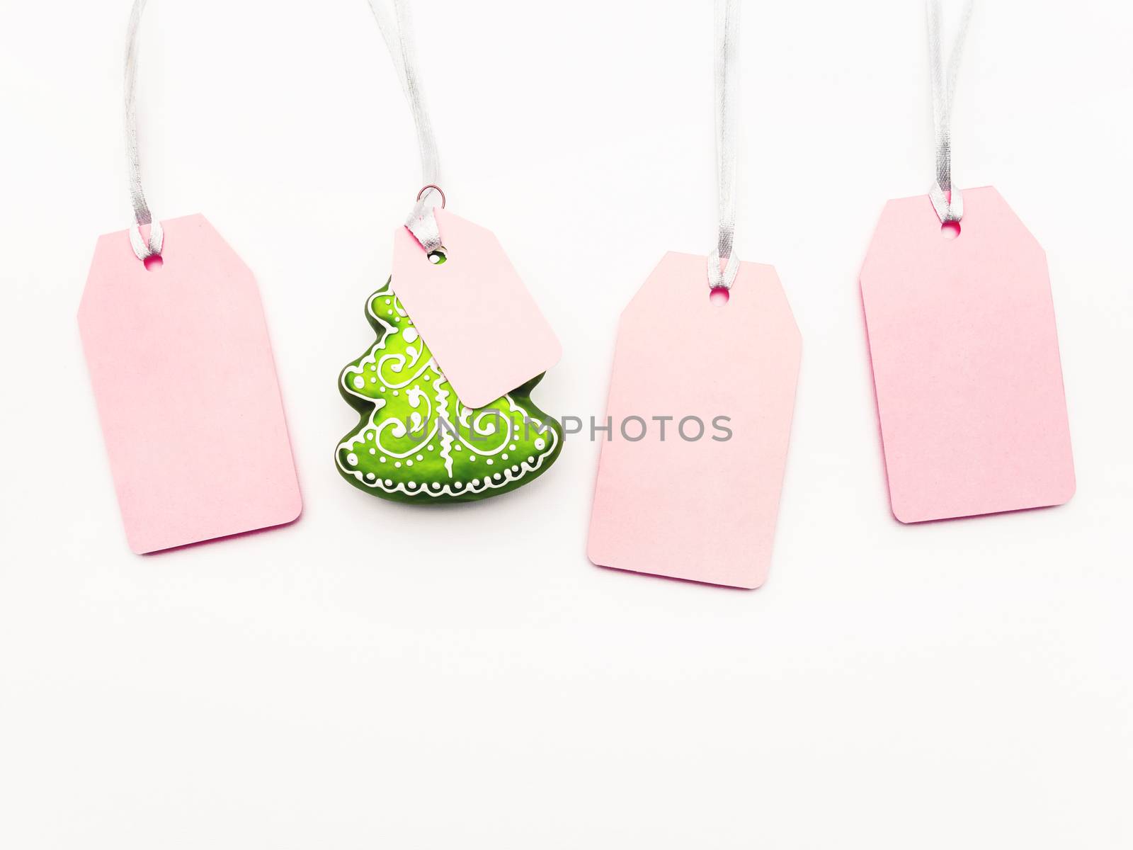 Four pink clear tags and decorative Chrsitmas tree on white back by aksenovko