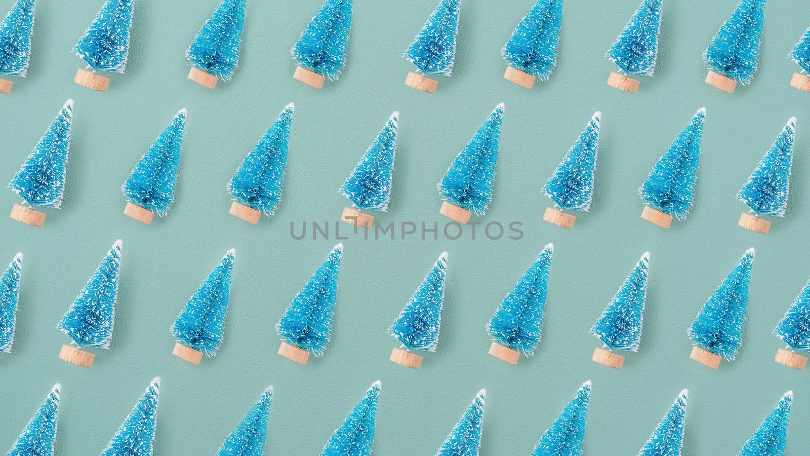 Top view of Christmas holiday pattern decoration ornament composition with Christmas tree objects flat lay with copy space isolated on green background.