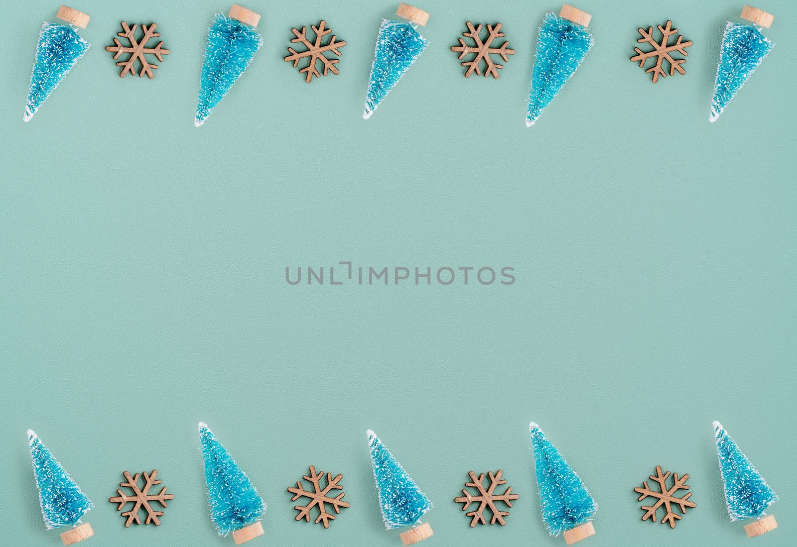 Top view of Christmas holiday pattern decoration ornament composition with Christmas tree objects flat lay with copy space isolated on green background.
