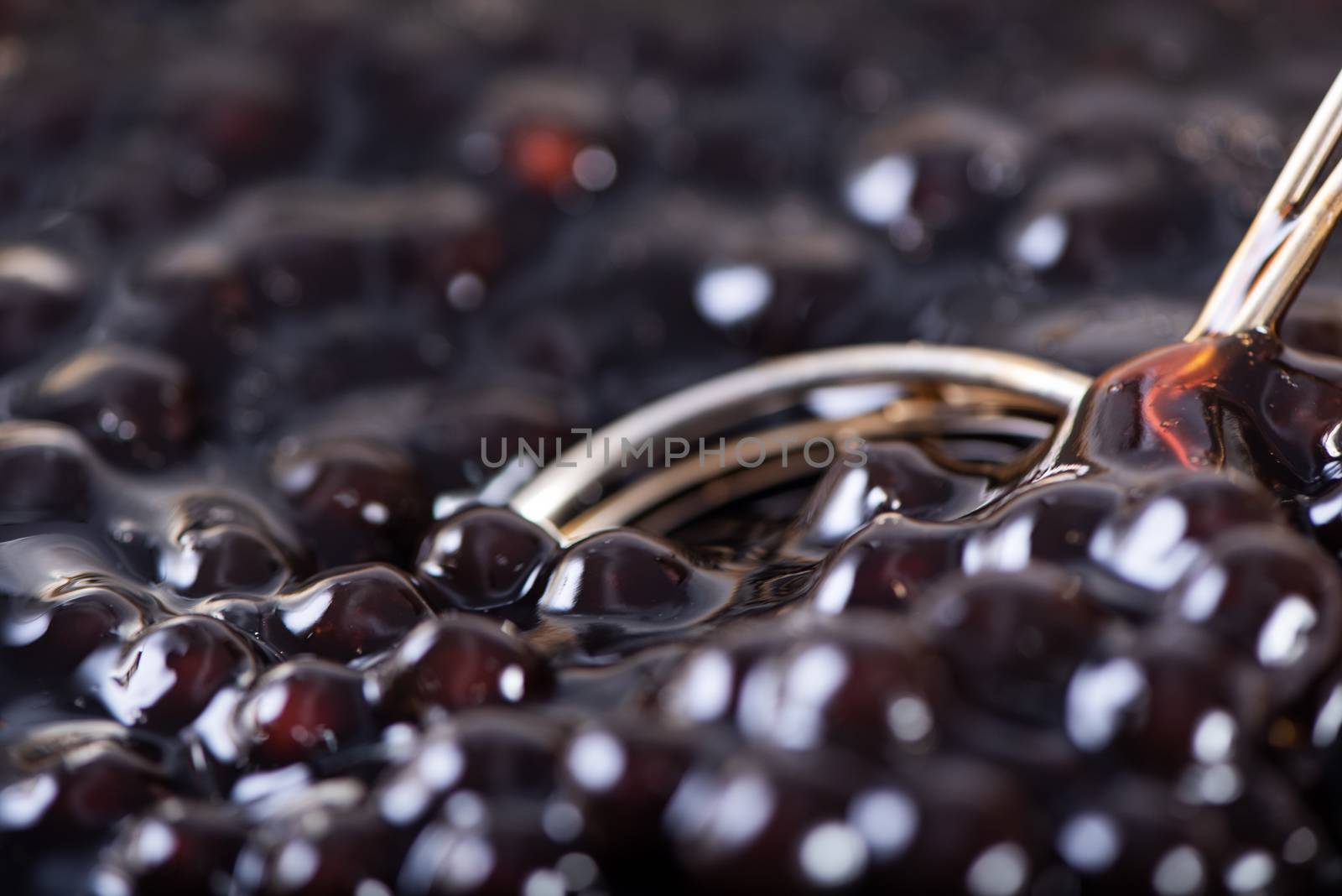 Cooking, boiling brown sugar flavored tapioca pearl balls, ingredient of bubble tea, preparing food and drink, close up, recipe cookbook steps design concept.