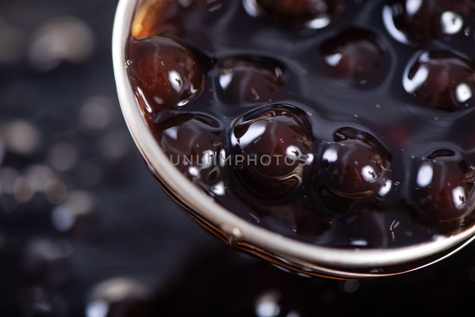 Cooking, boiling brown sugar flavored tapioca pearl balls, ingredient of bubble tea, preparing food and drink, close up, recipe cookbook steps design concept.