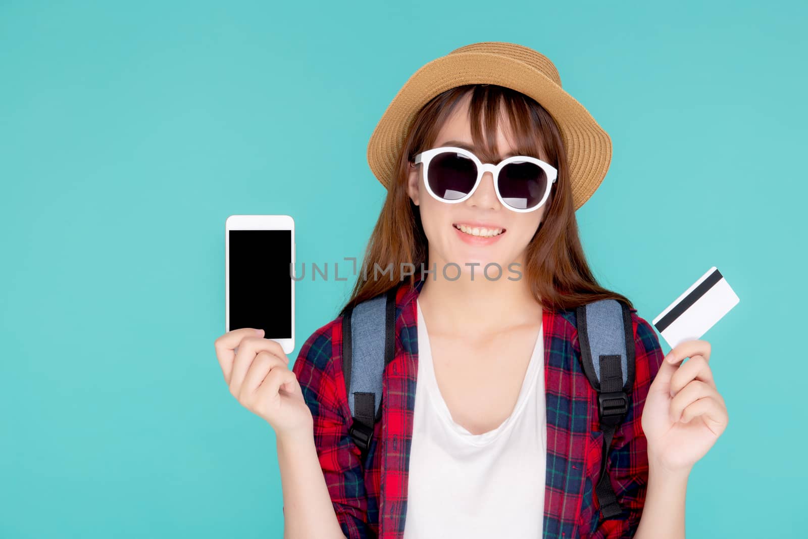 Beautiful portrait young asian woman wear travel summer fashion holding credit card and smart mobile phone in summer, asia girl payment for booking internet online with app in vacation.